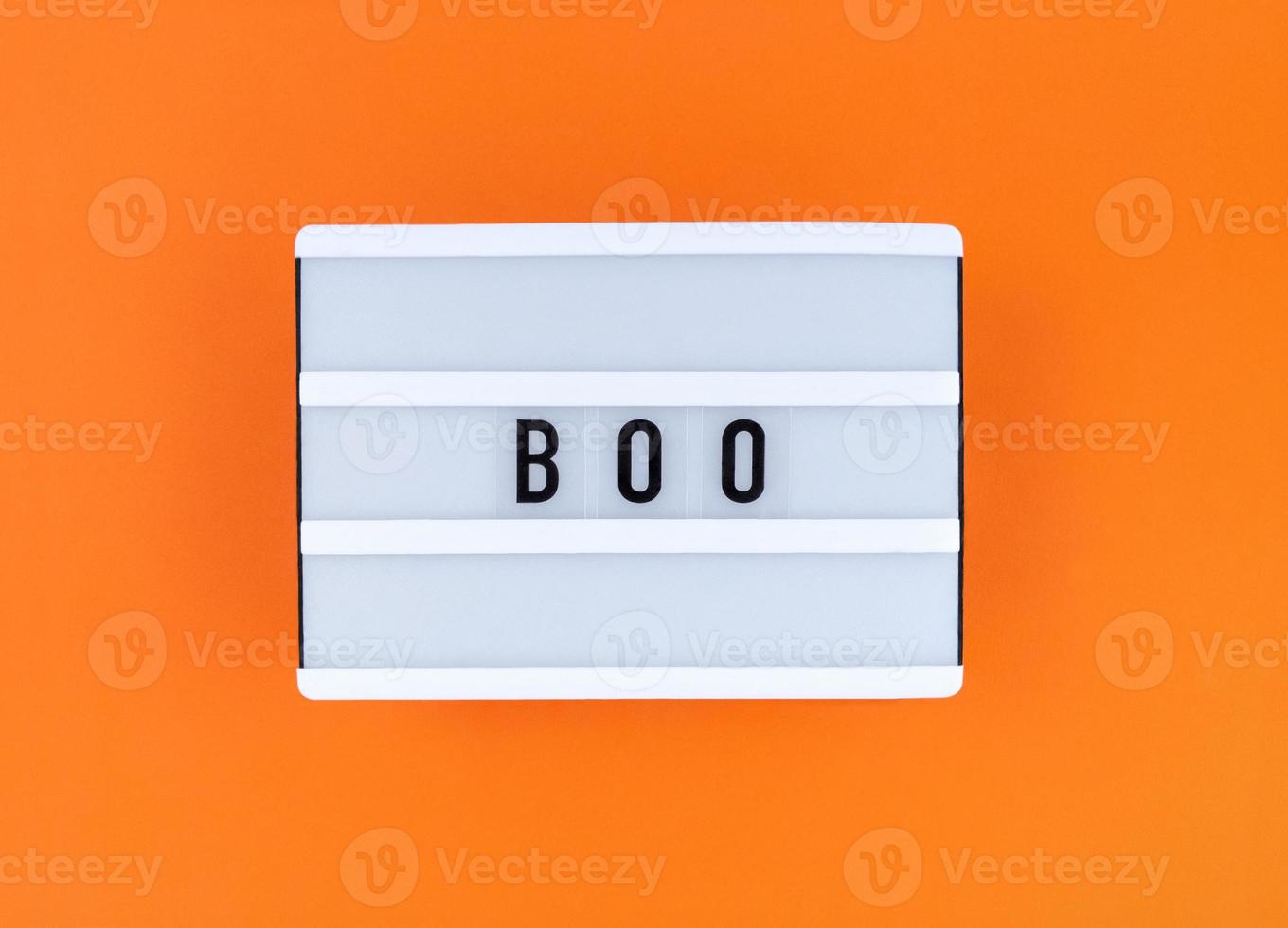 Light box with Boo word on an orange background. photo