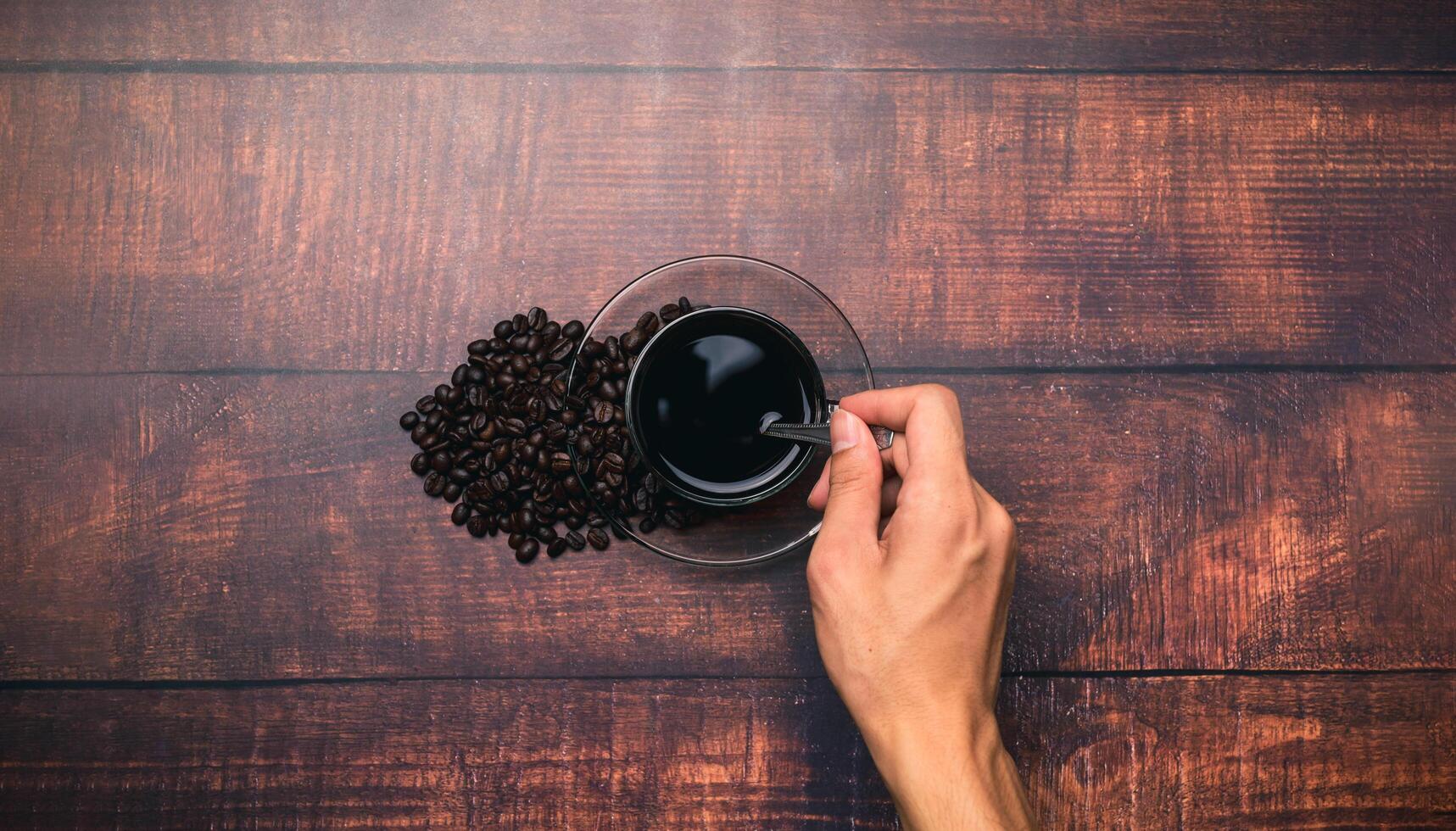 mano haciendo bebida de café para obtener energía foto