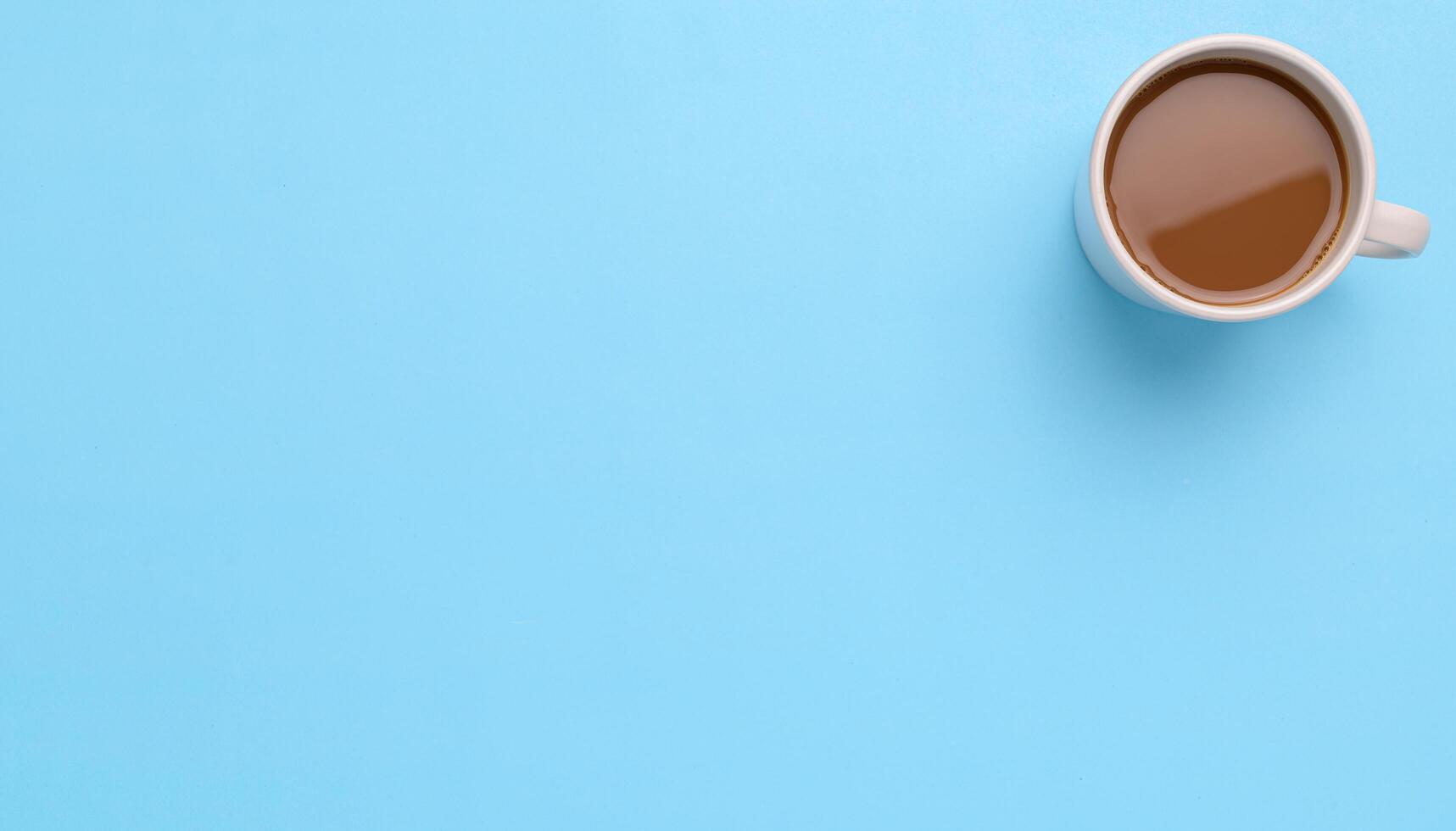 Cup of coffee on a blue background photo