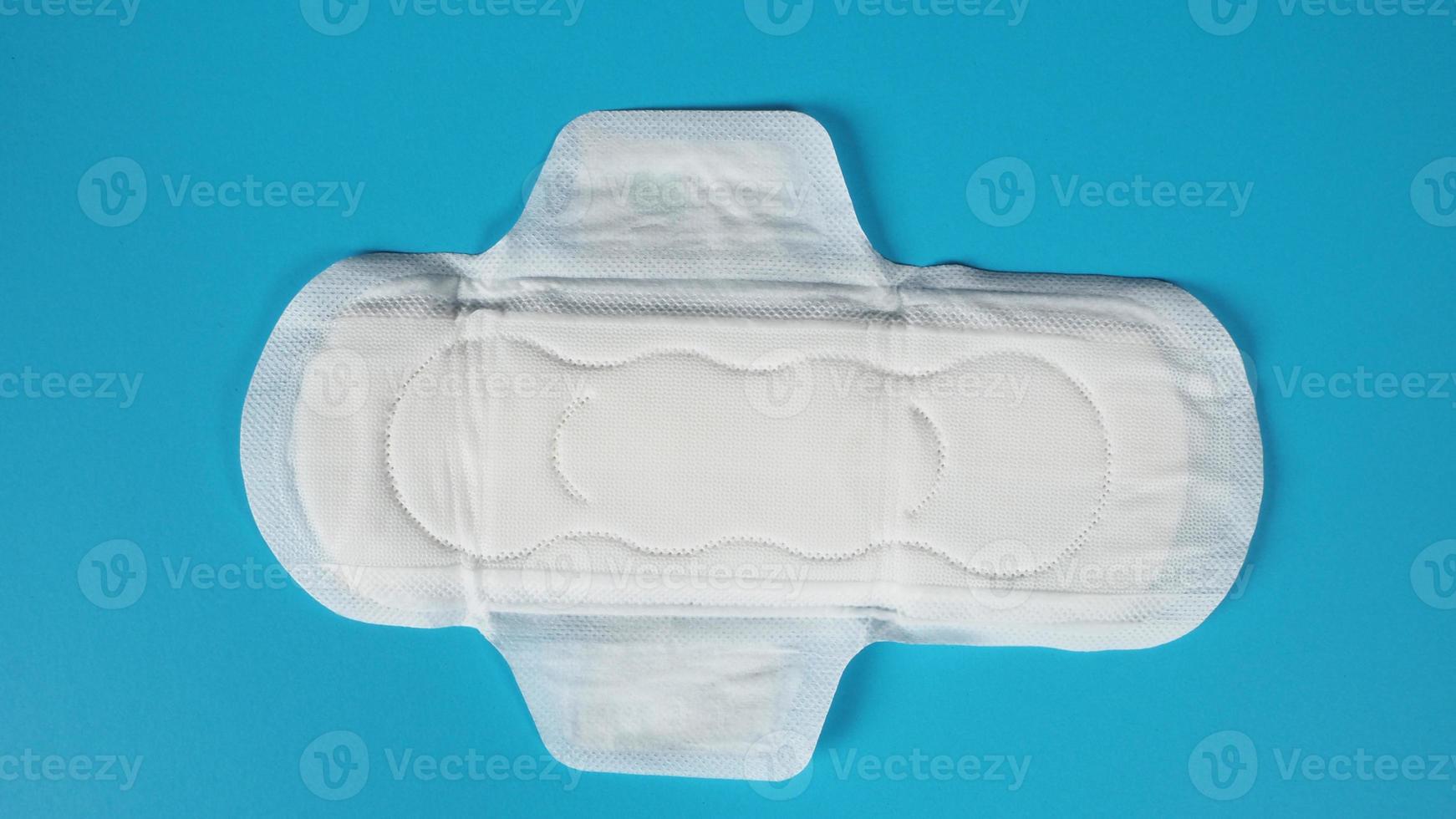 sanitary napkin top angle view on blue background. photo