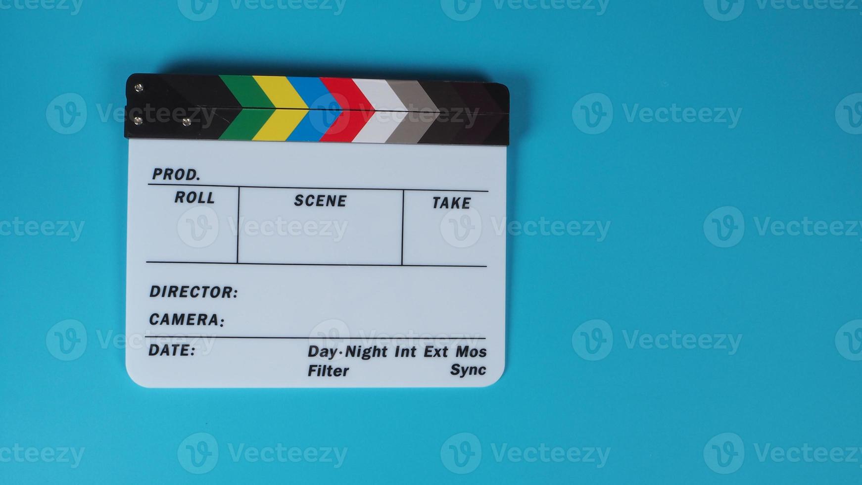 Clapperboard or movie slate on blue background. photo