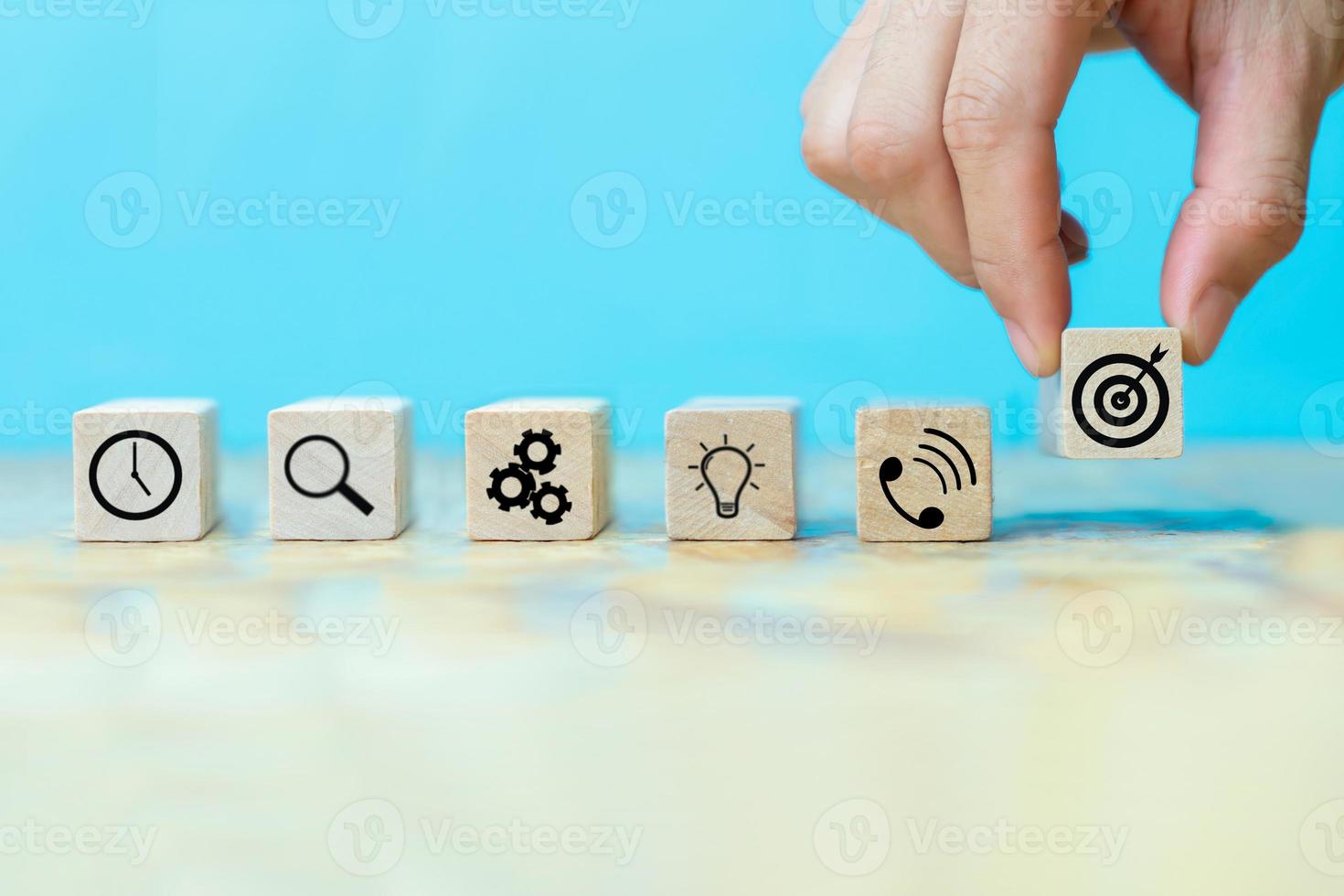 Businessman hand arranging wood block with icon business strategy photo