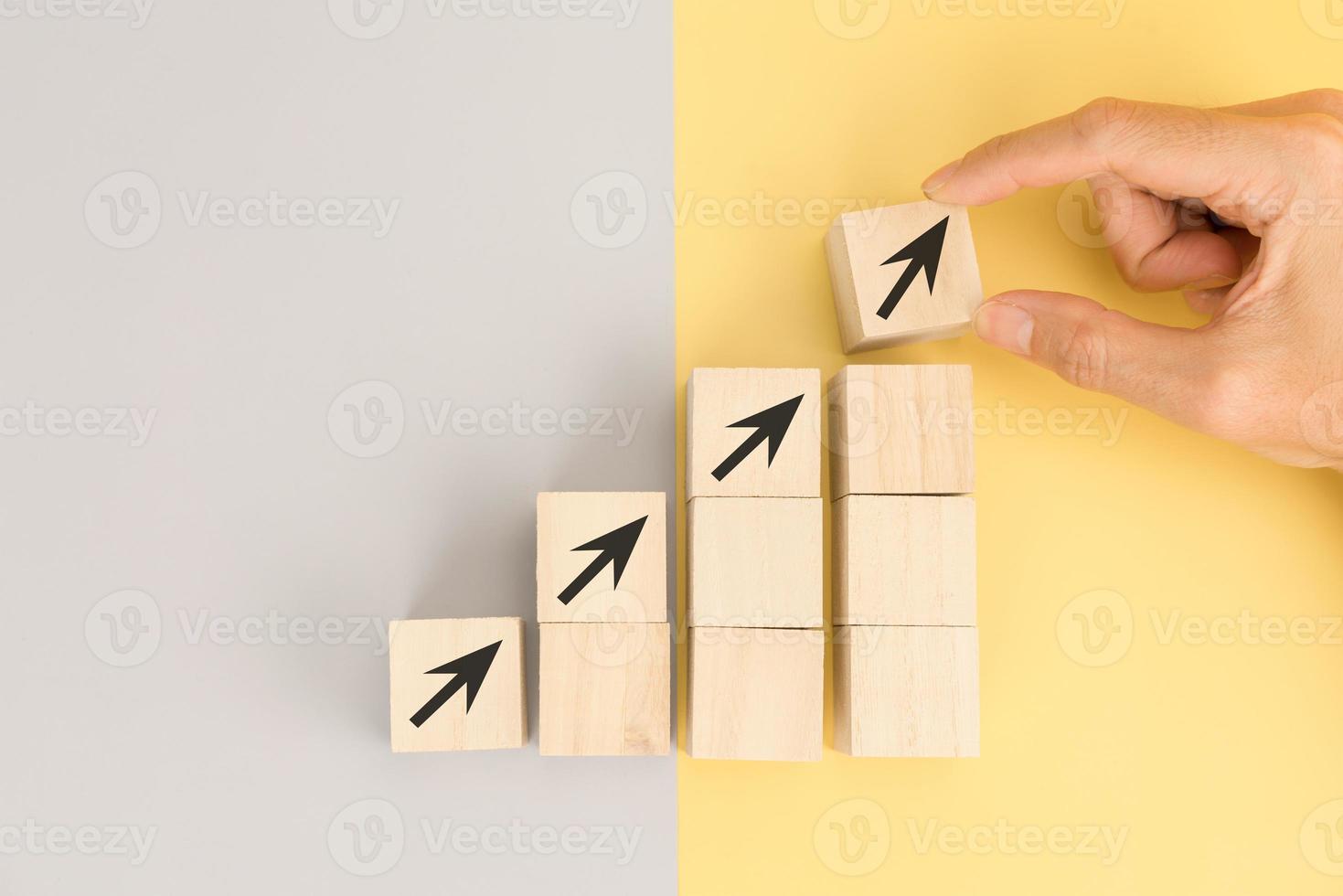 Hand arranging wood block for business growth and process for success photo