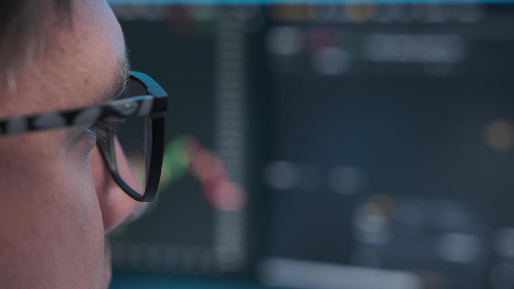 Close up view of focused businessman wears computer glasses photo