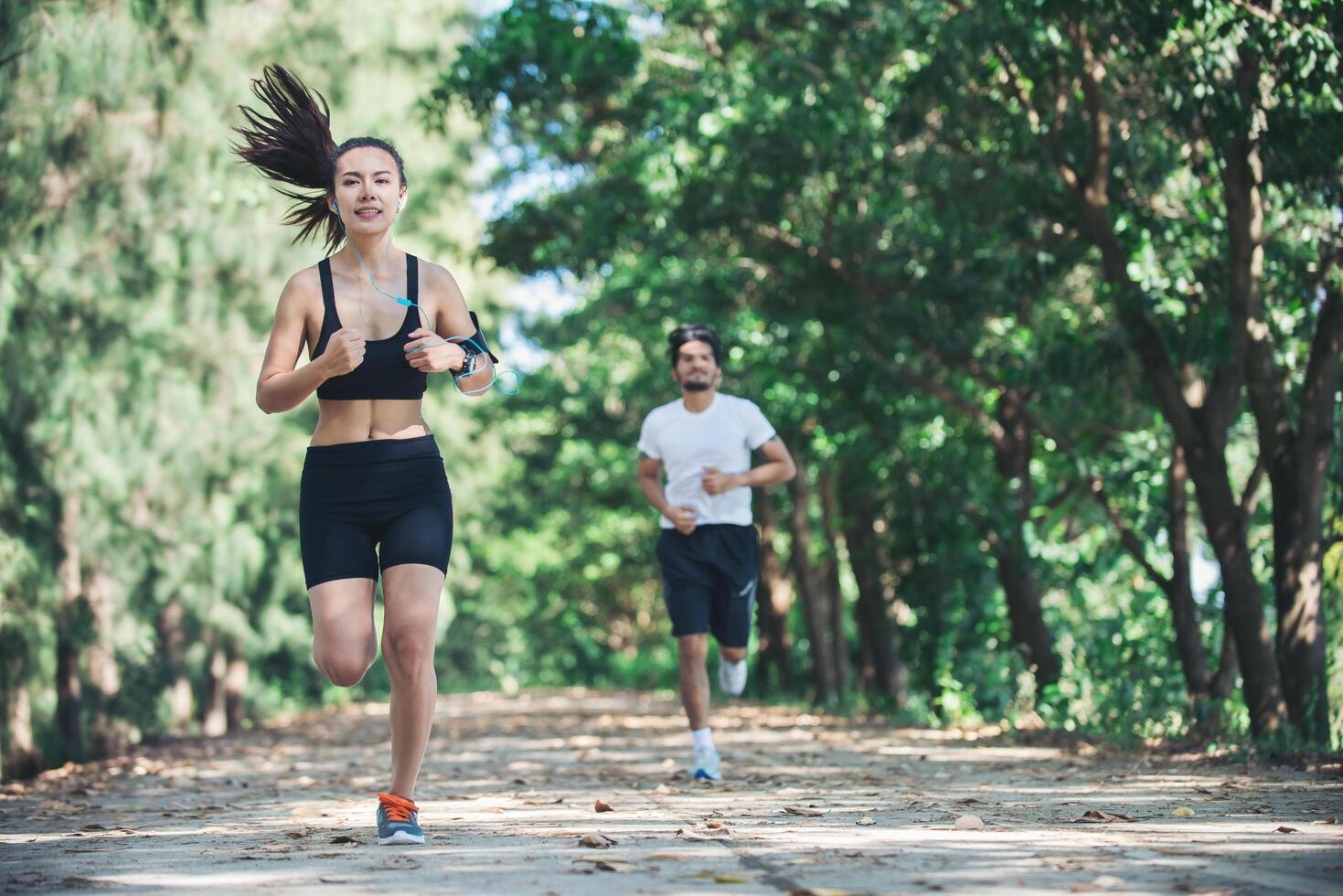 Young couple running in the park. photo