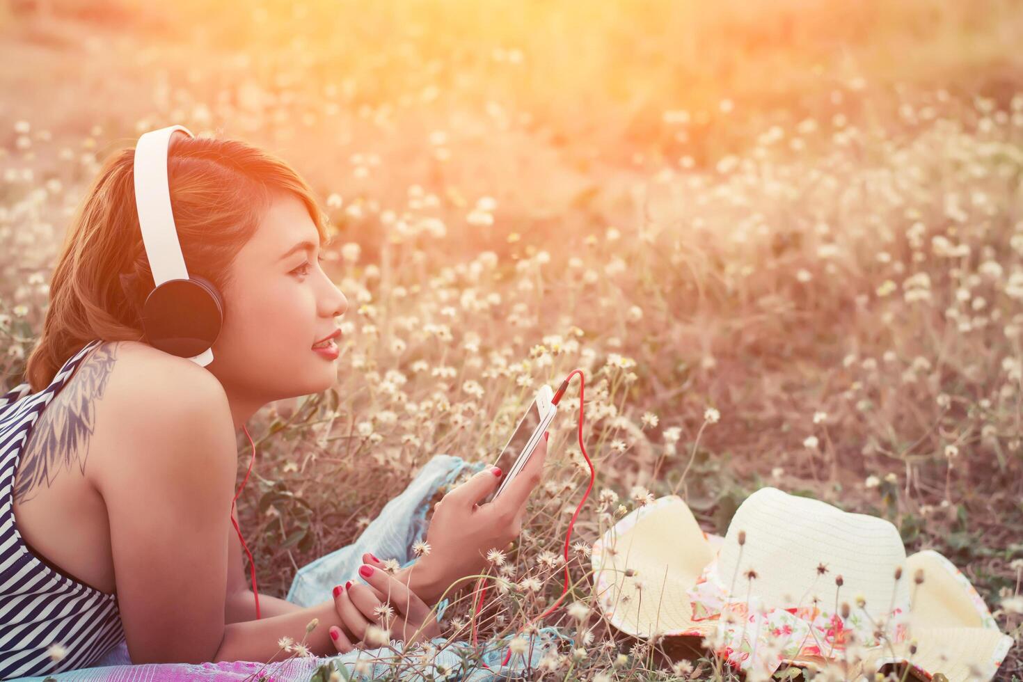 Close-up woman hands using smartphone to listening music laying. photo