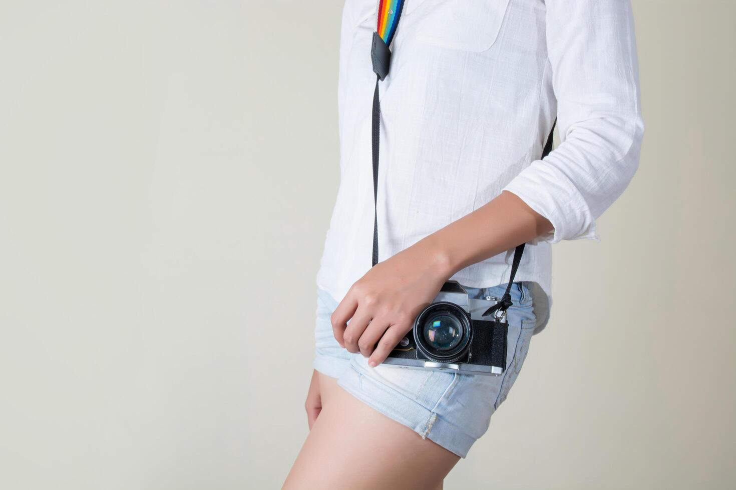 Beautiful young woman photographer holding retro camera photo