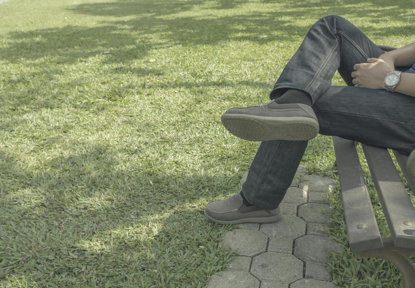 Sad man sitting alone in the park photo