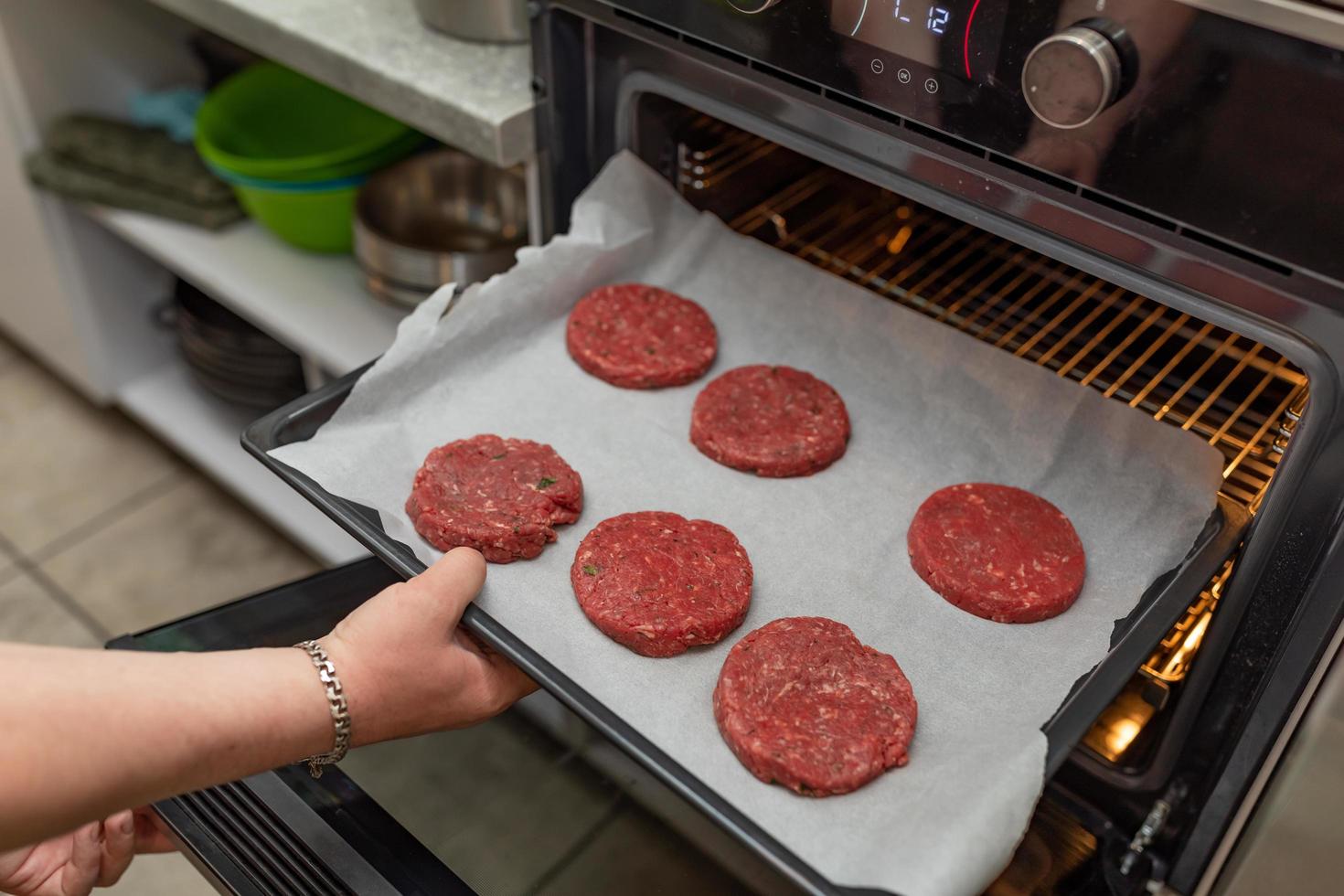 Putting hamburgers in the oven photo