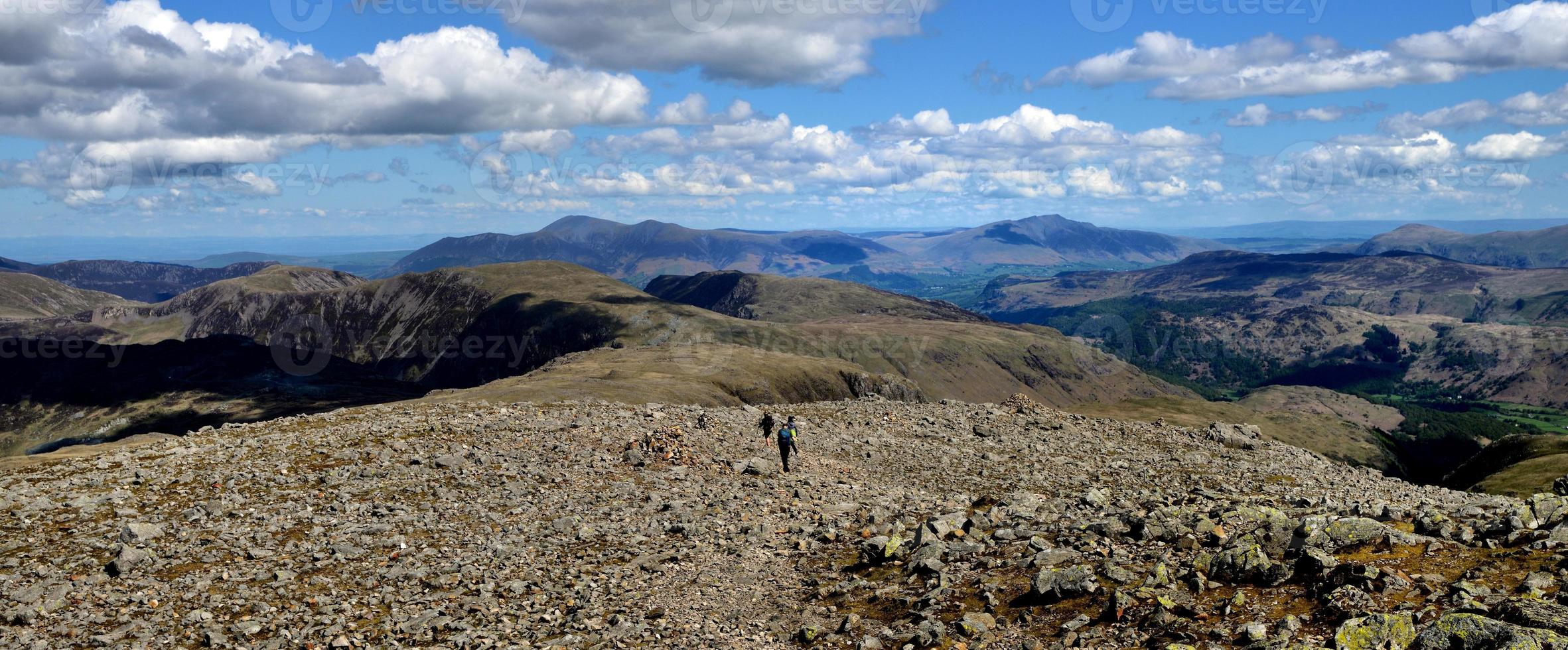 Hikers following the track off the summit photo