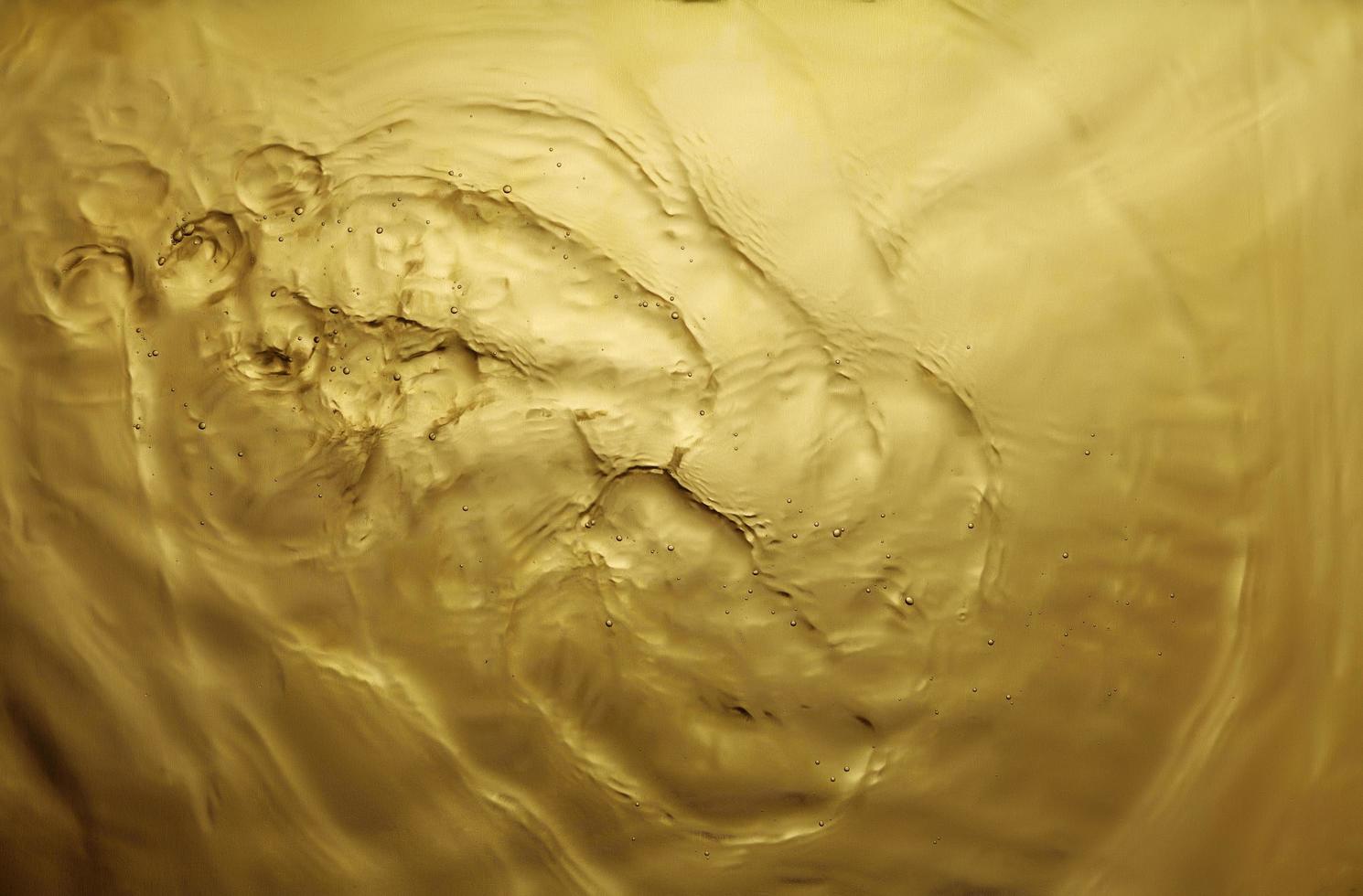 texture of splashing water on gold background photo