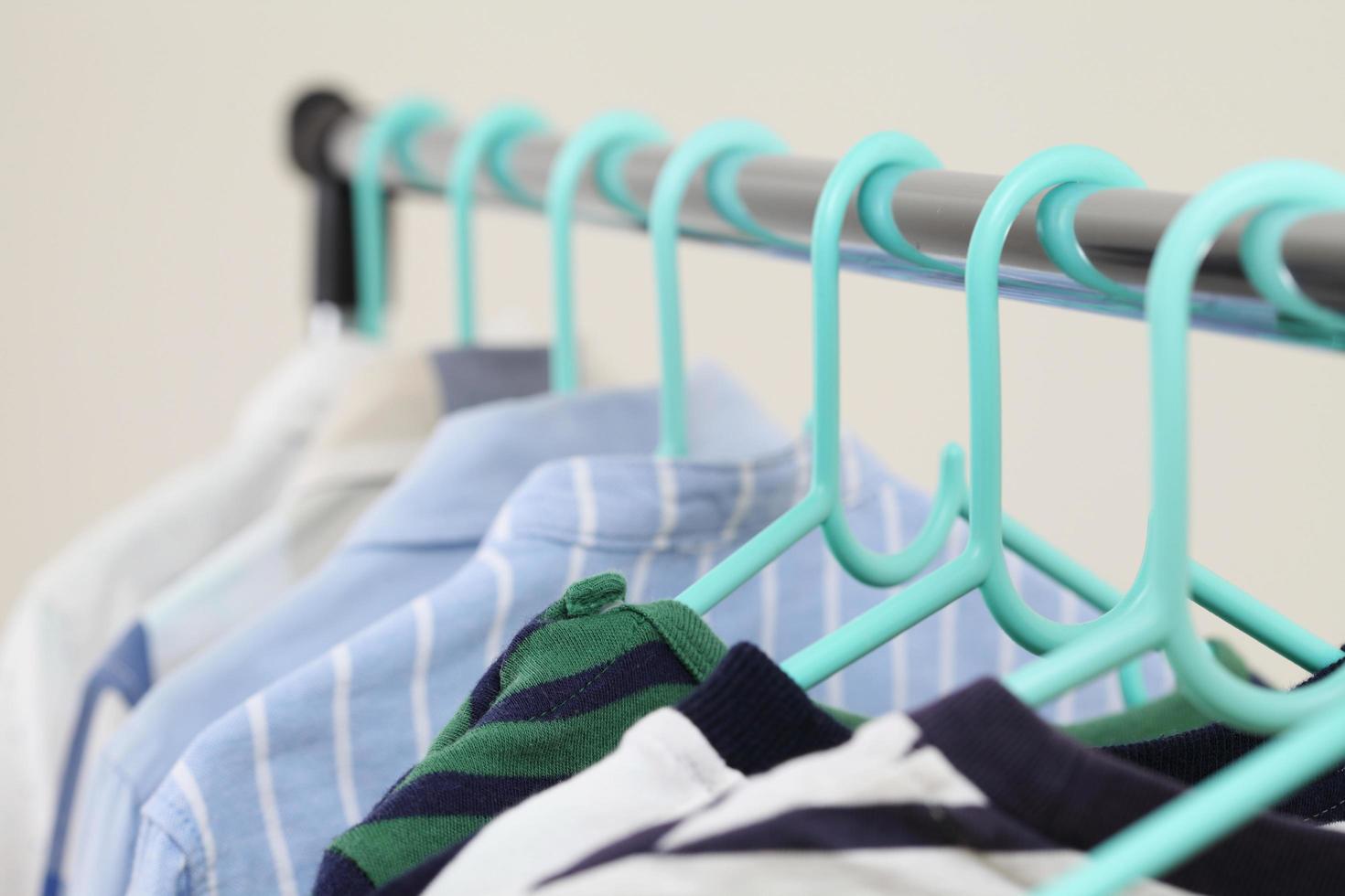 Pastel kid shirts hanging on rack photo