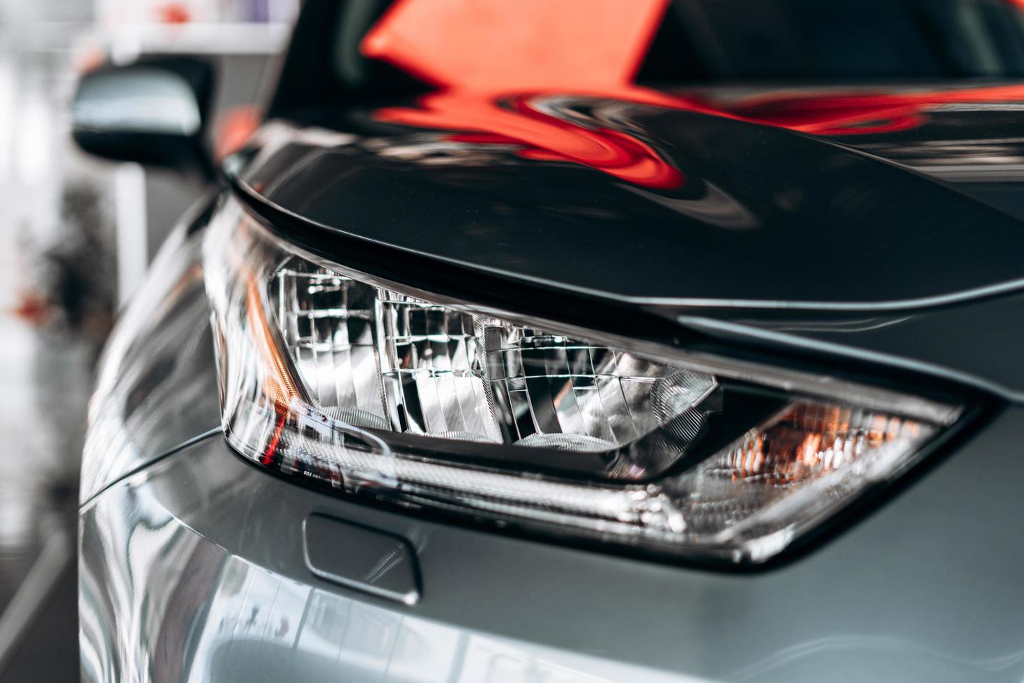 Closeup of a headlight on a modern car with reflection. photo