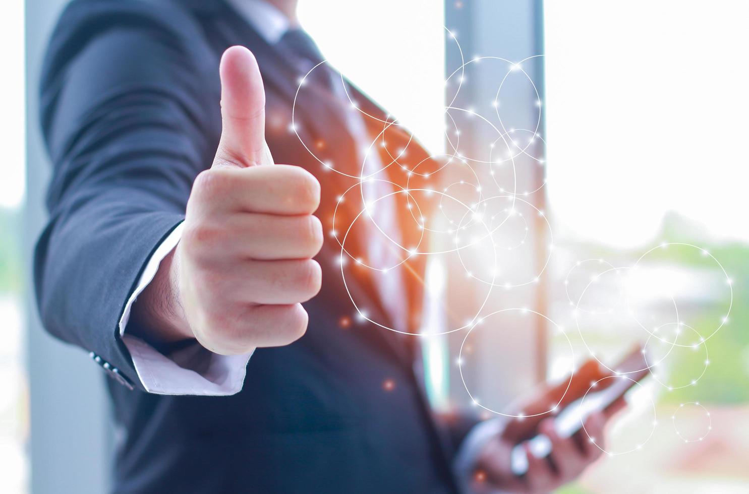 businessman showing thumbs up telecommunication connection photo