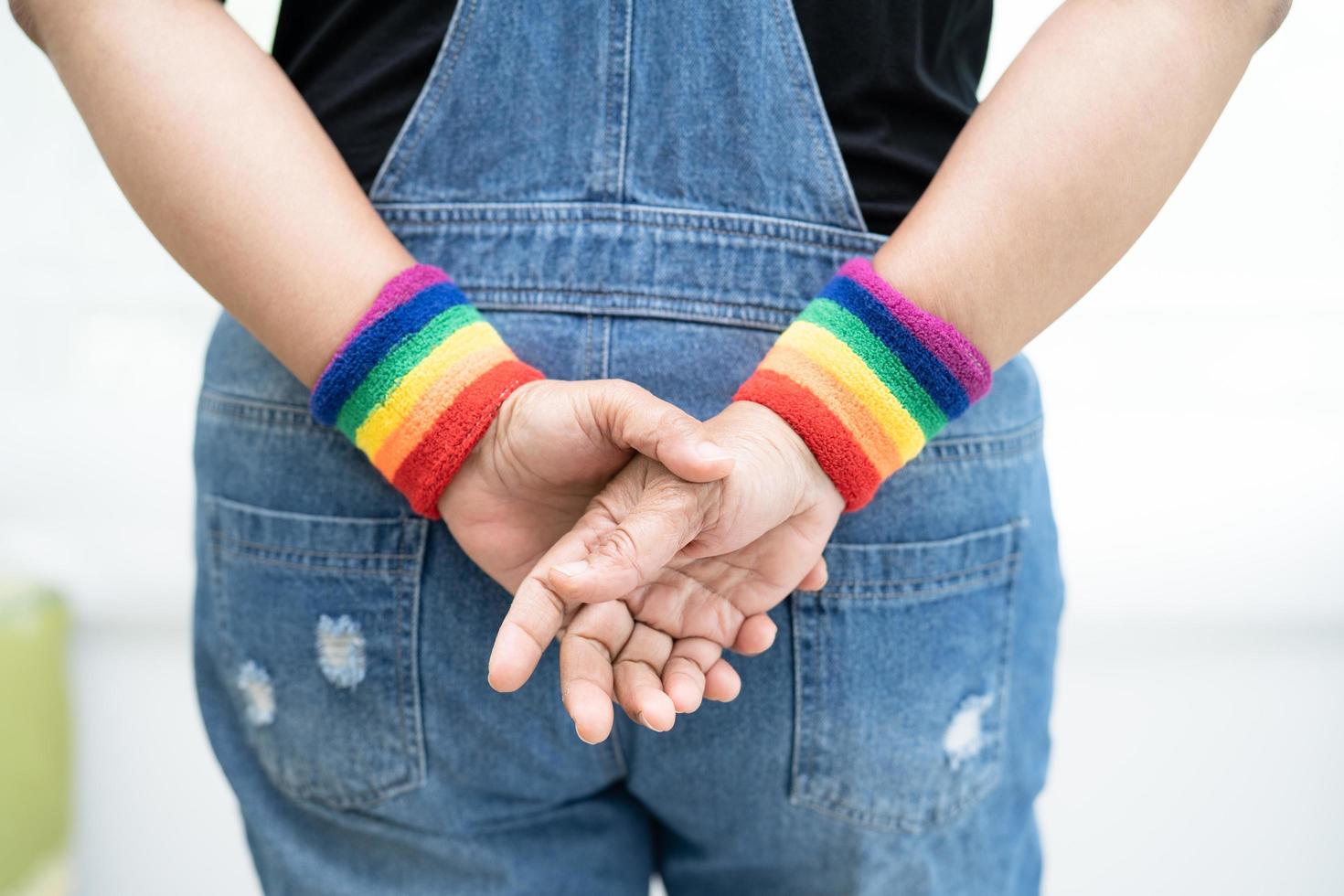 Asian lady wearing rainbow flag wristbands photo