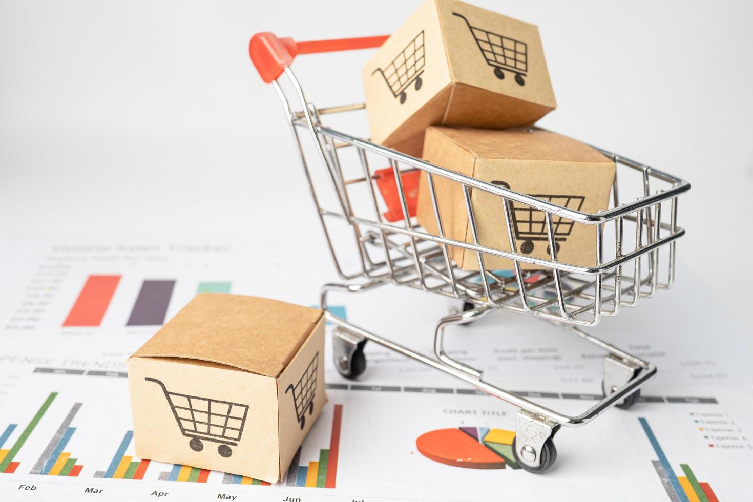 Shopping cart logo with box on graph photo