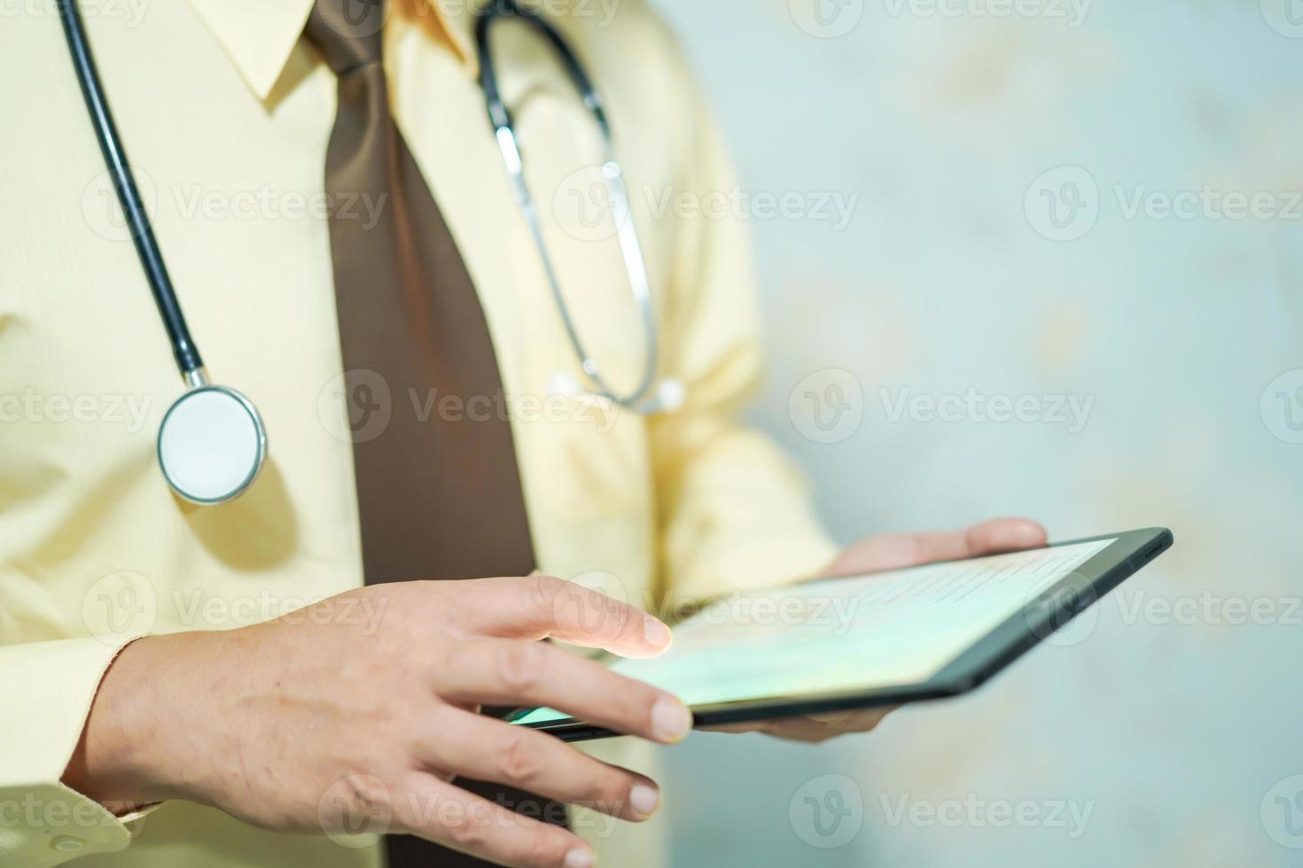 Doctor use tablet search data in hospital photo