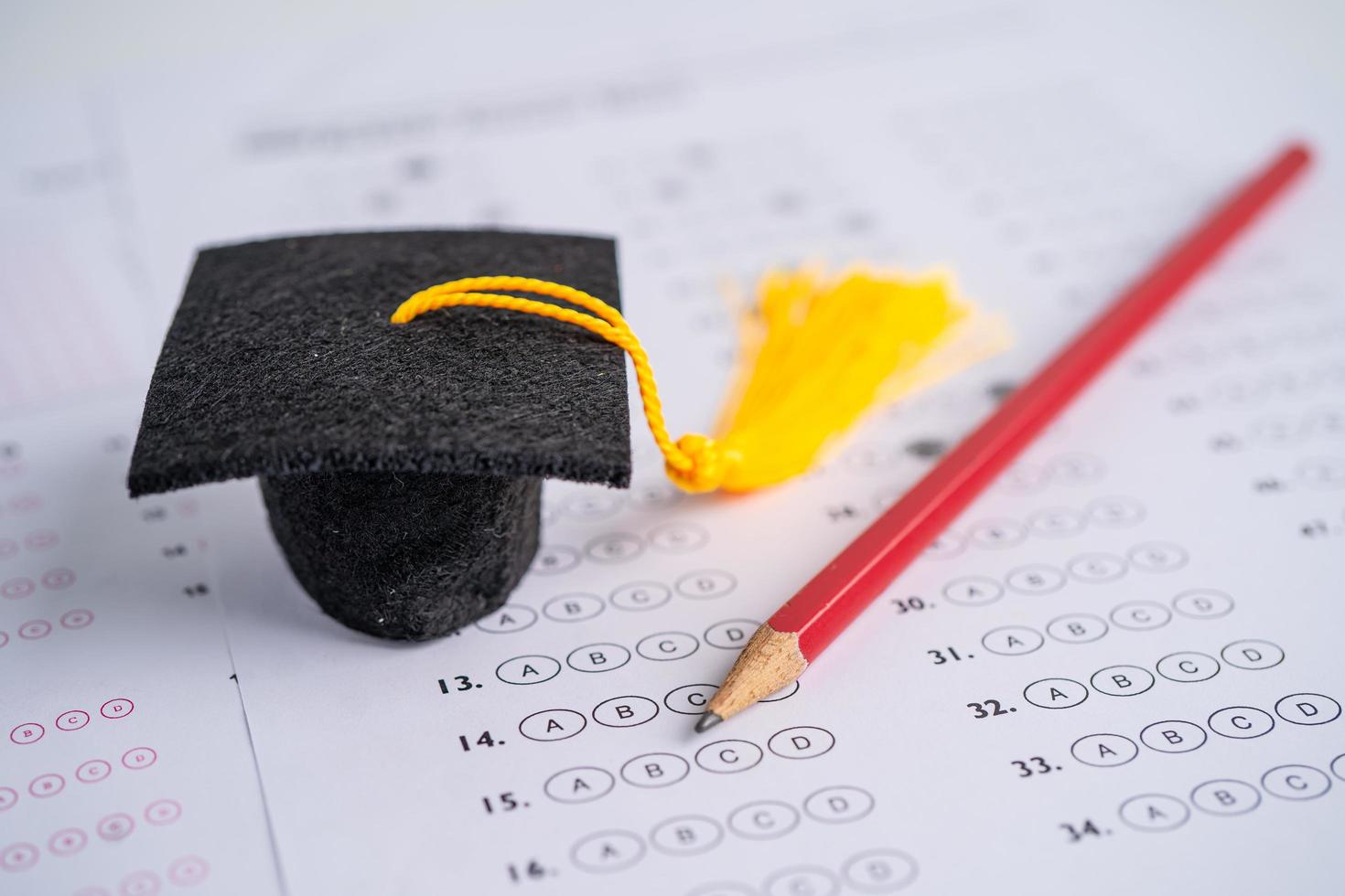 Graduation gap hat and pencil on answer sheet photo
