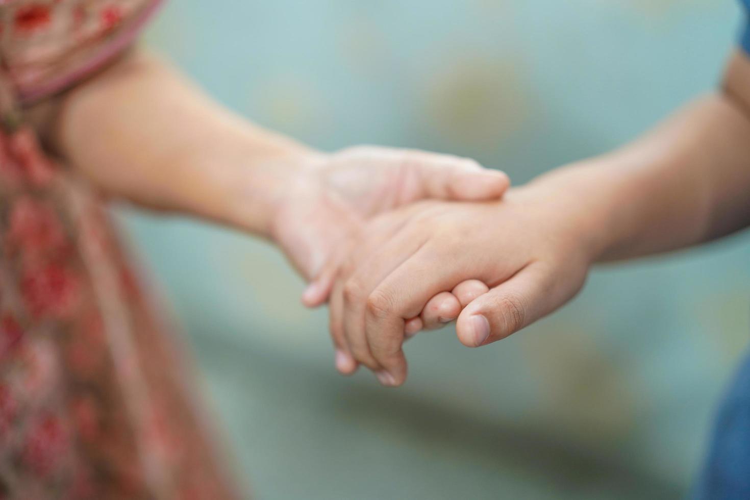 Kid holding old senior grandmother with love and care photo