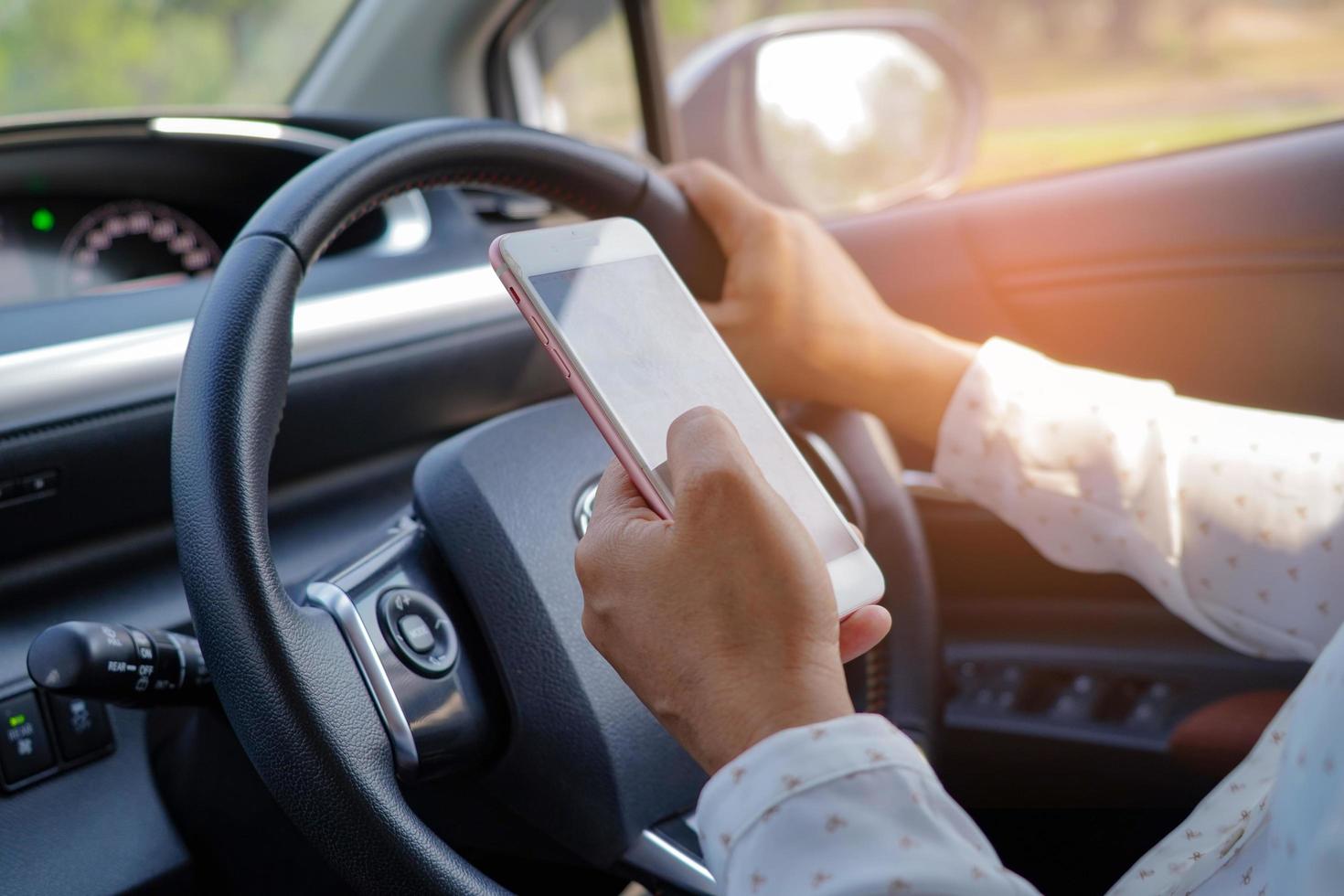 Asian lady holding mobile phone to communication in car. photo