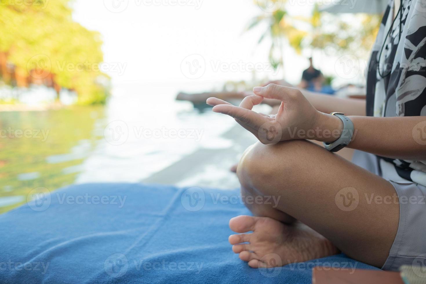 Woman doing lotus position closeup photo