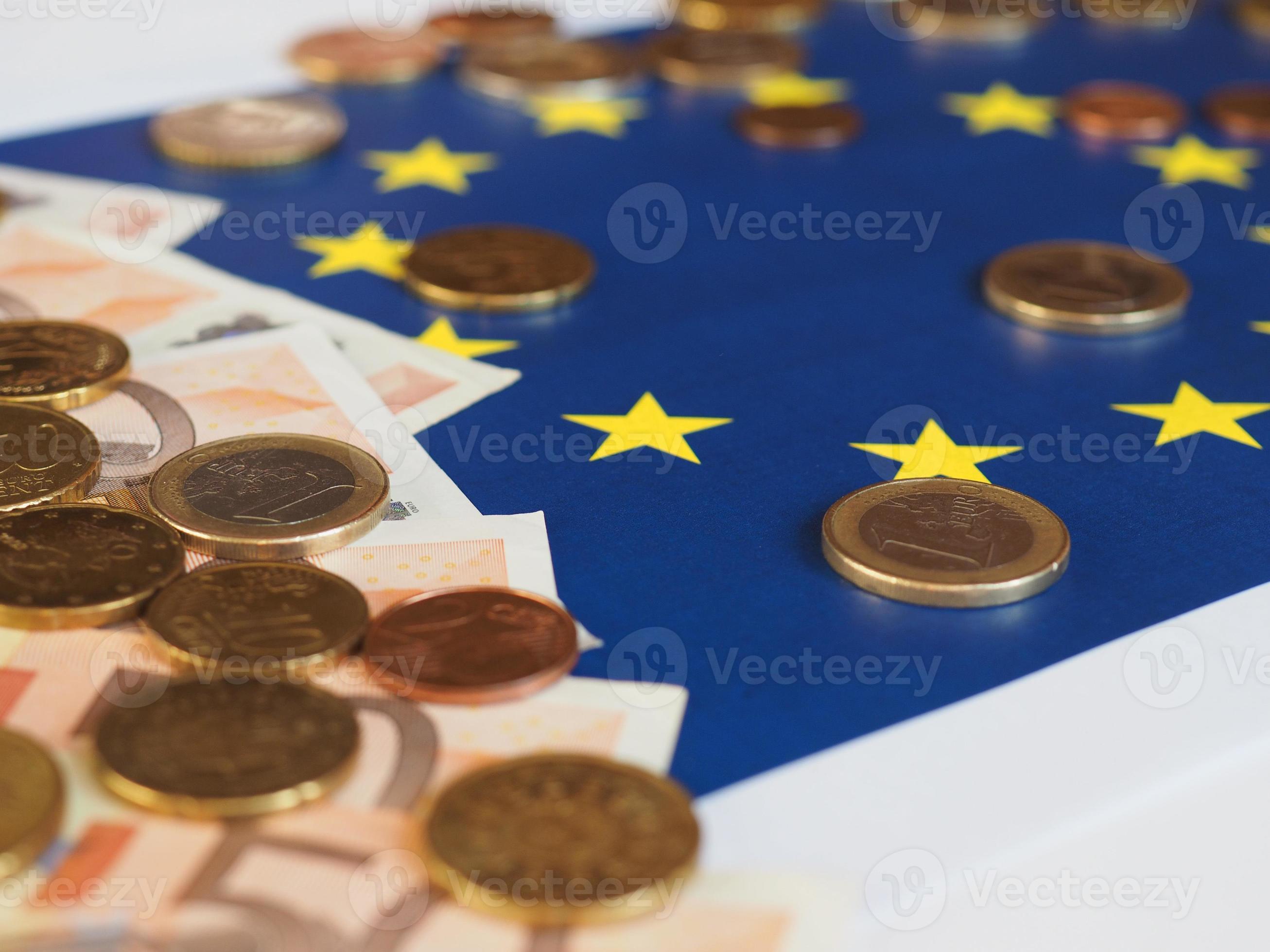 Euro notes and coins, European Union, over flag photo