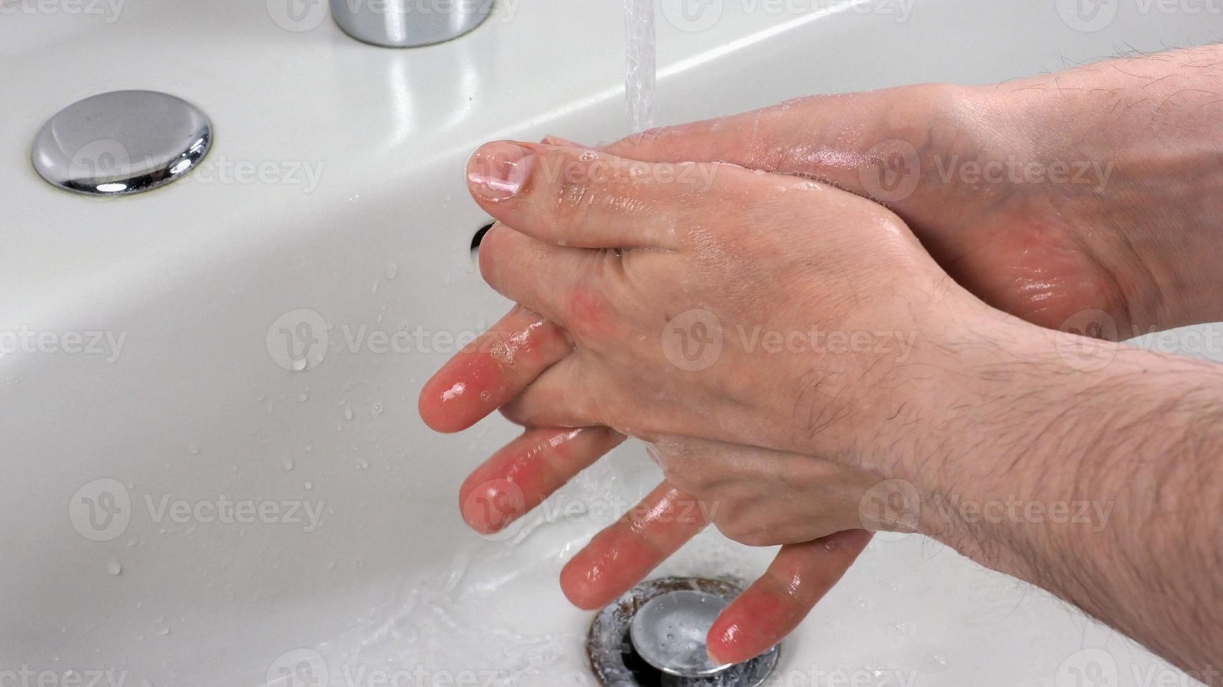 Unrecognisable person washing hands photo