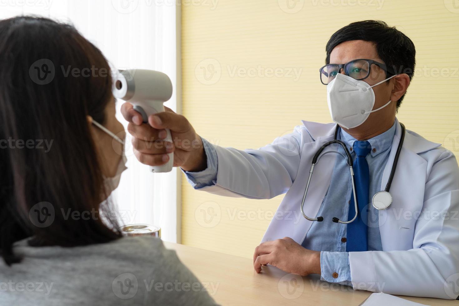 doctor using digital thermometer to measure temperature of patient photo