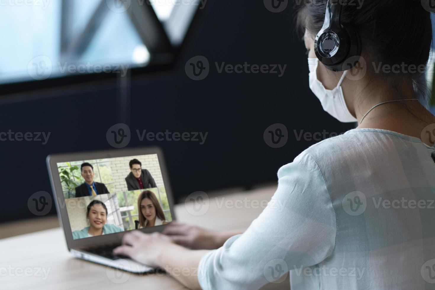 asian businesswoman video call with colleagues from home photo