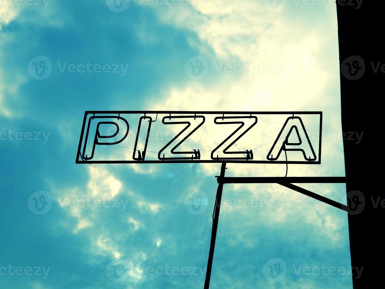 signo de pizza sobre el cielo foto
