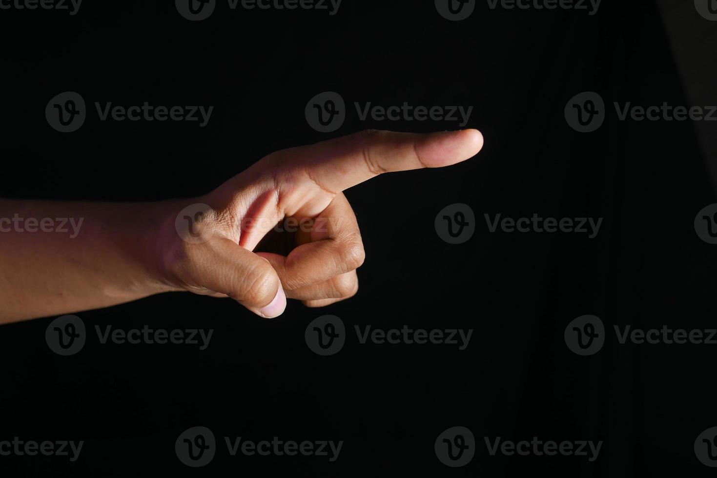 man hand pointing finger isolated on black photo