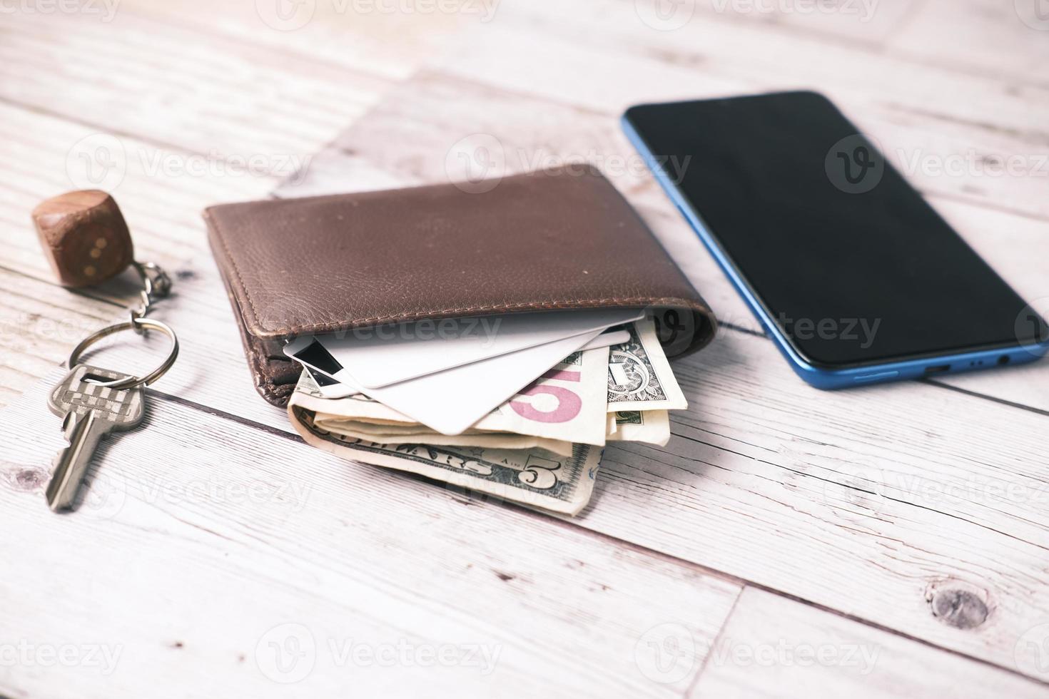 close up of wallet, cash and credit card on table photo