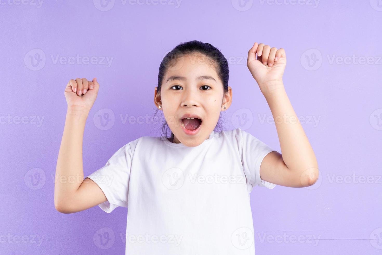 Portrait of Asian child on purple background photo