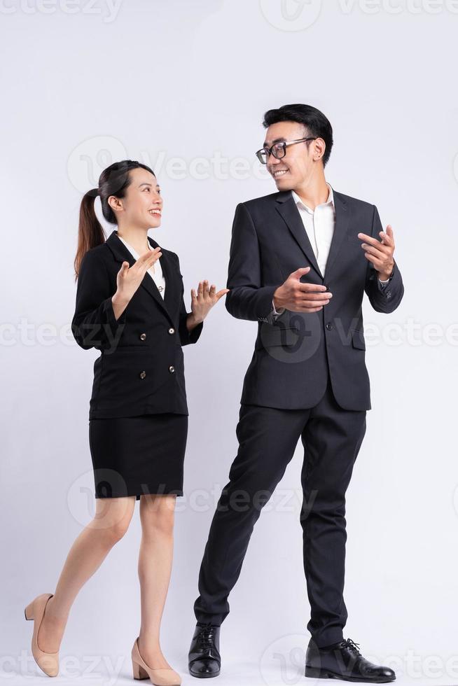 Asian businessman and businesswoman walking and talking photo