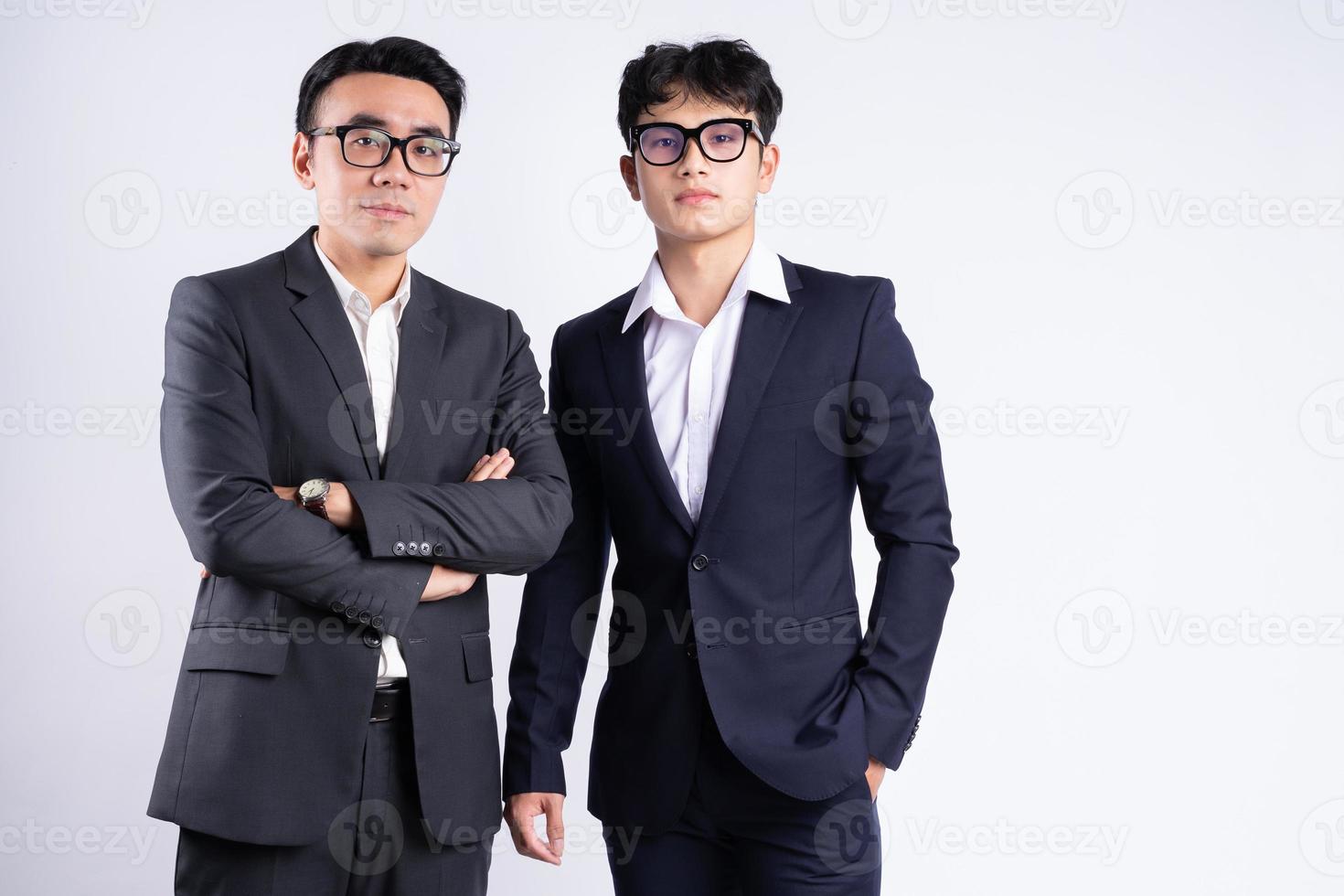 Two Asian businessman posing on white background photo