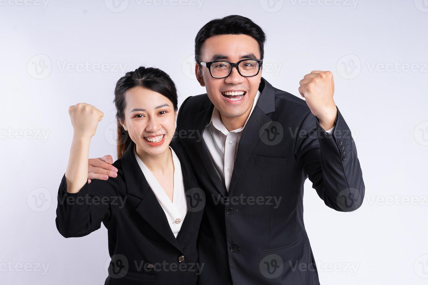 Asian businessman and businesswoman posing on white background photo