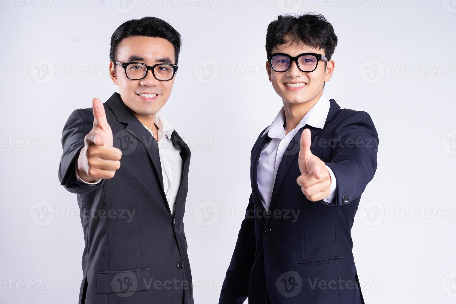 Two Asian businessman posing on white background photo