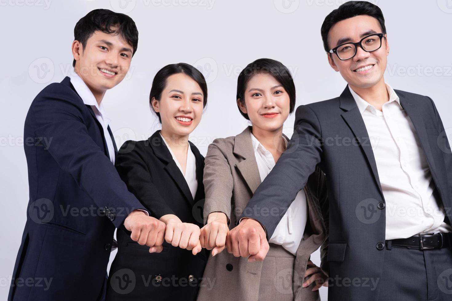 Group of Asian business people posing on a white background photo