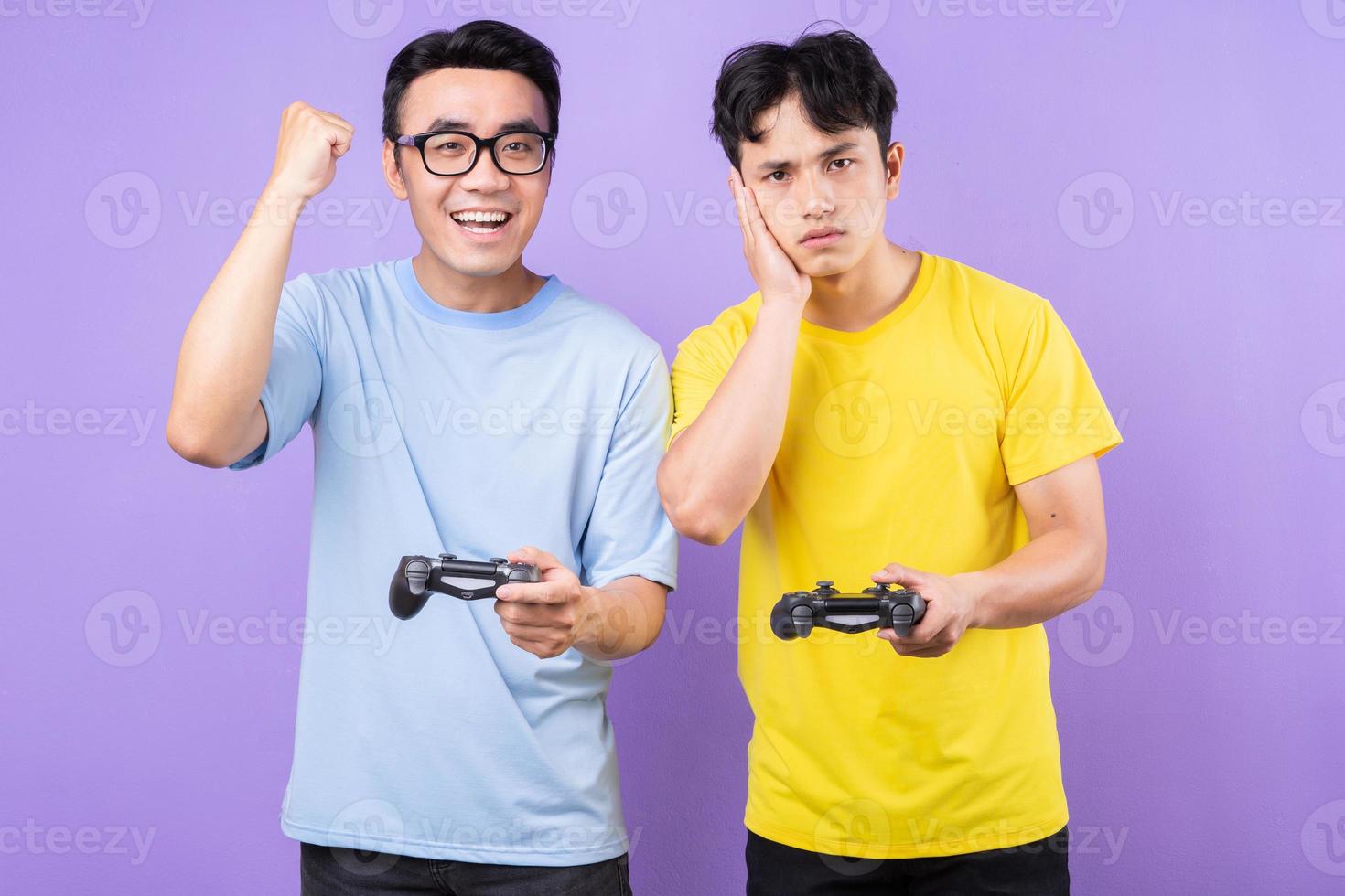 Two Asian brothers playing games together photo