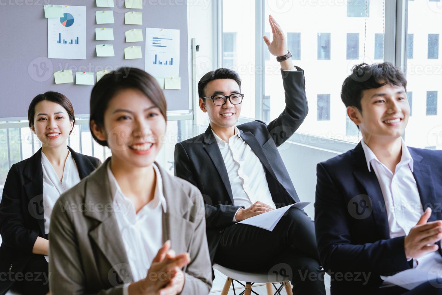 Portrait of Asian businessman raising his hand photo