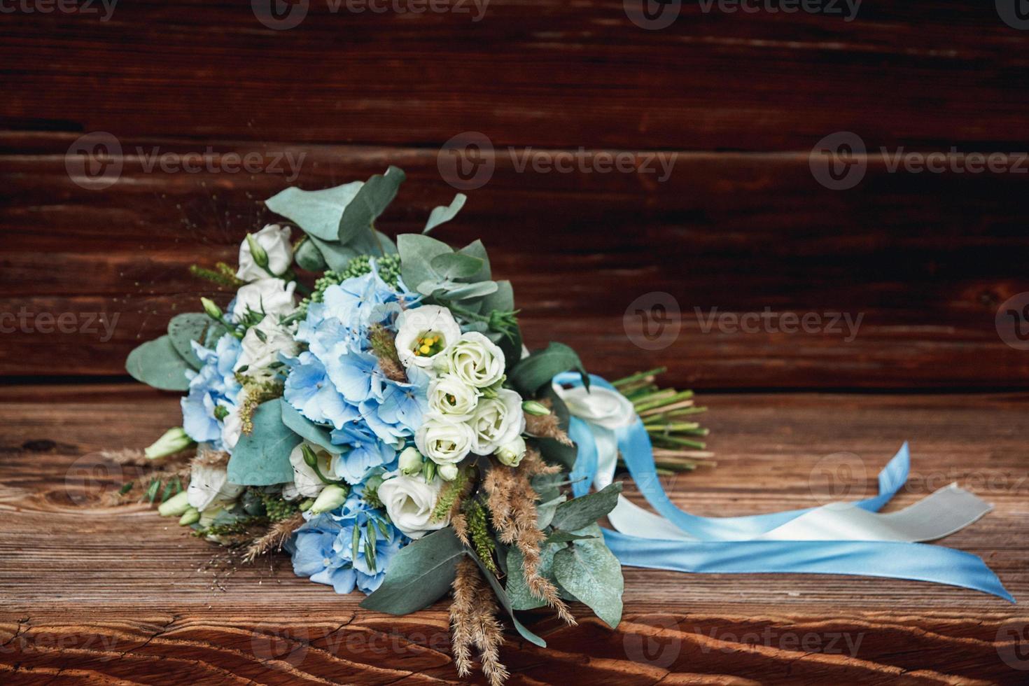 wedding bouquet lying on a wooden surface photo