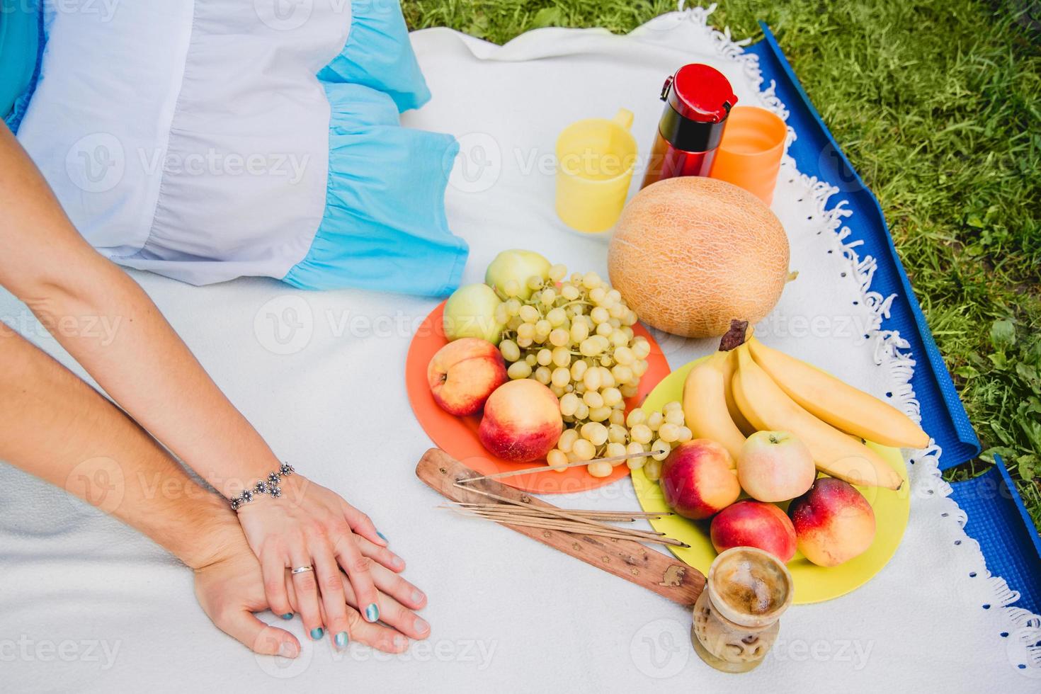Young couple eating grapes and enjoying in picnic photo