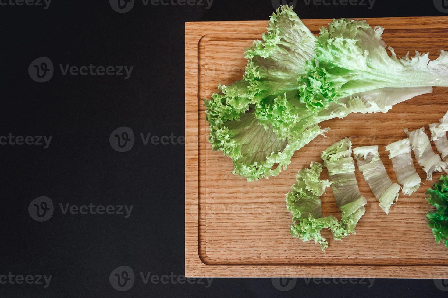 Sliced cabbage leaves on a wooden board photo