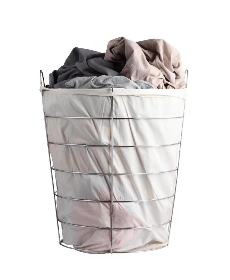Basket with dirty laundry on white background photo