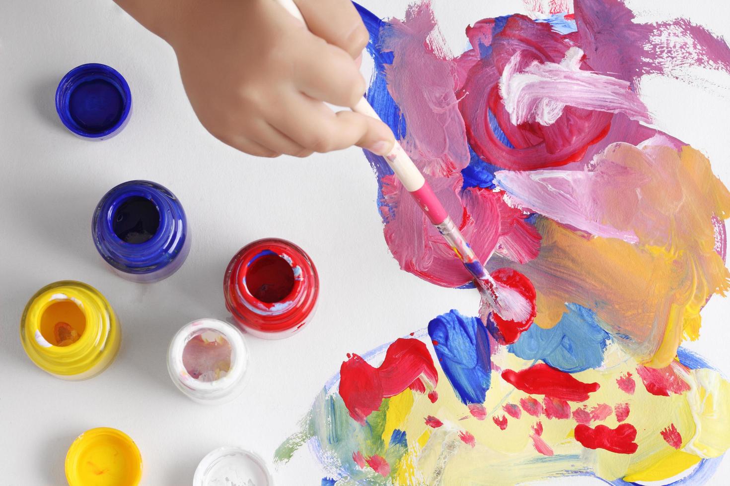 Asian boy use paintbrush and watercolor painting photo