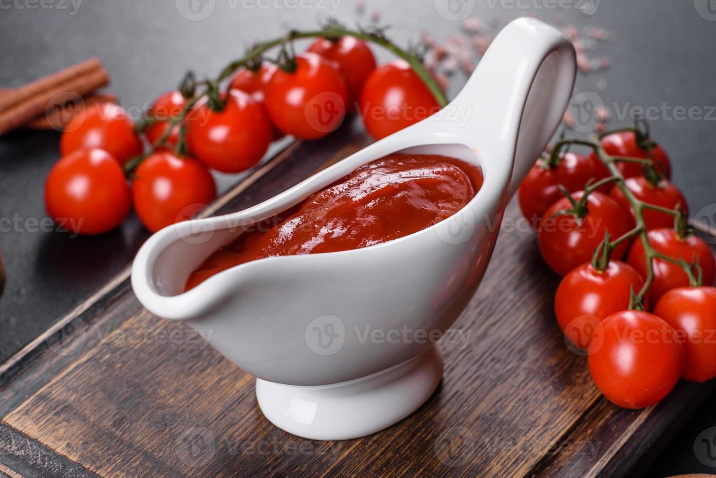 Red sauce or ketchup in a bowl and ingredients for cooking photo