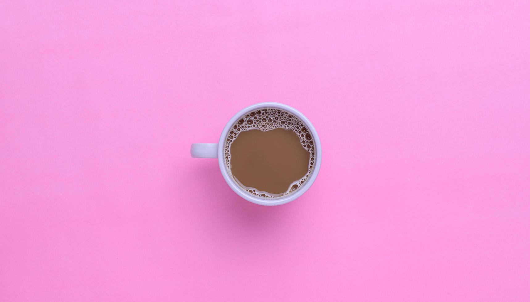 Coffee mug on a pink background photo