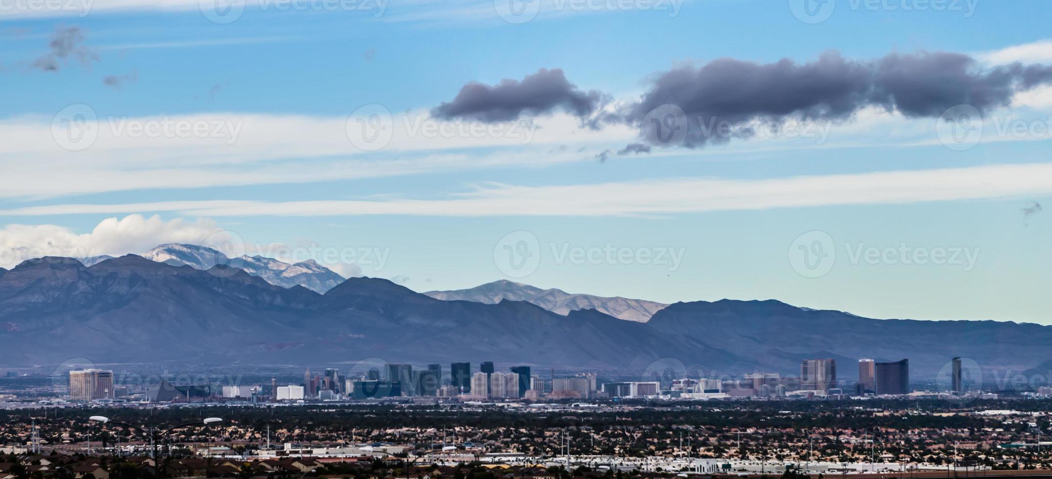 Las Vegas city surrounded by Red Rock mountains and Valley of Fire photo