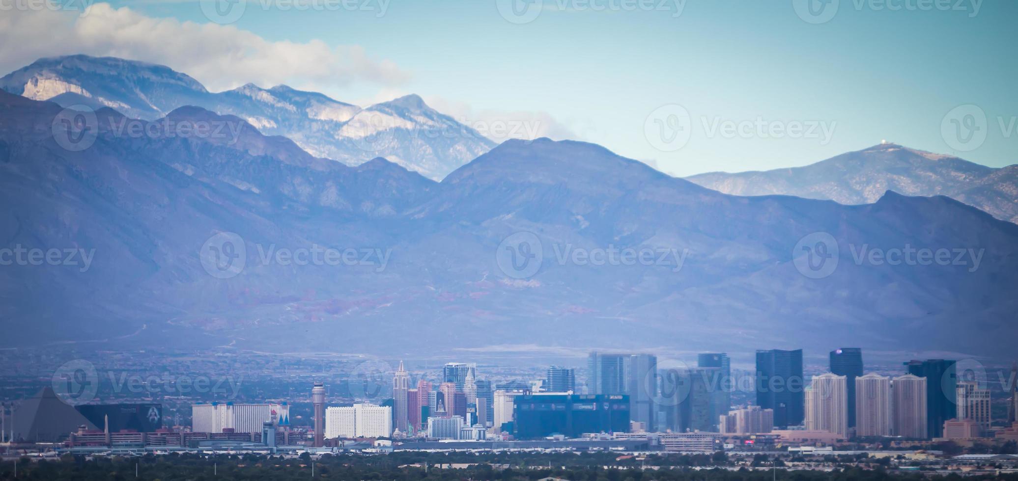 Las Vegas city surrounded by Red Rock mountains and Valley of Fire photo