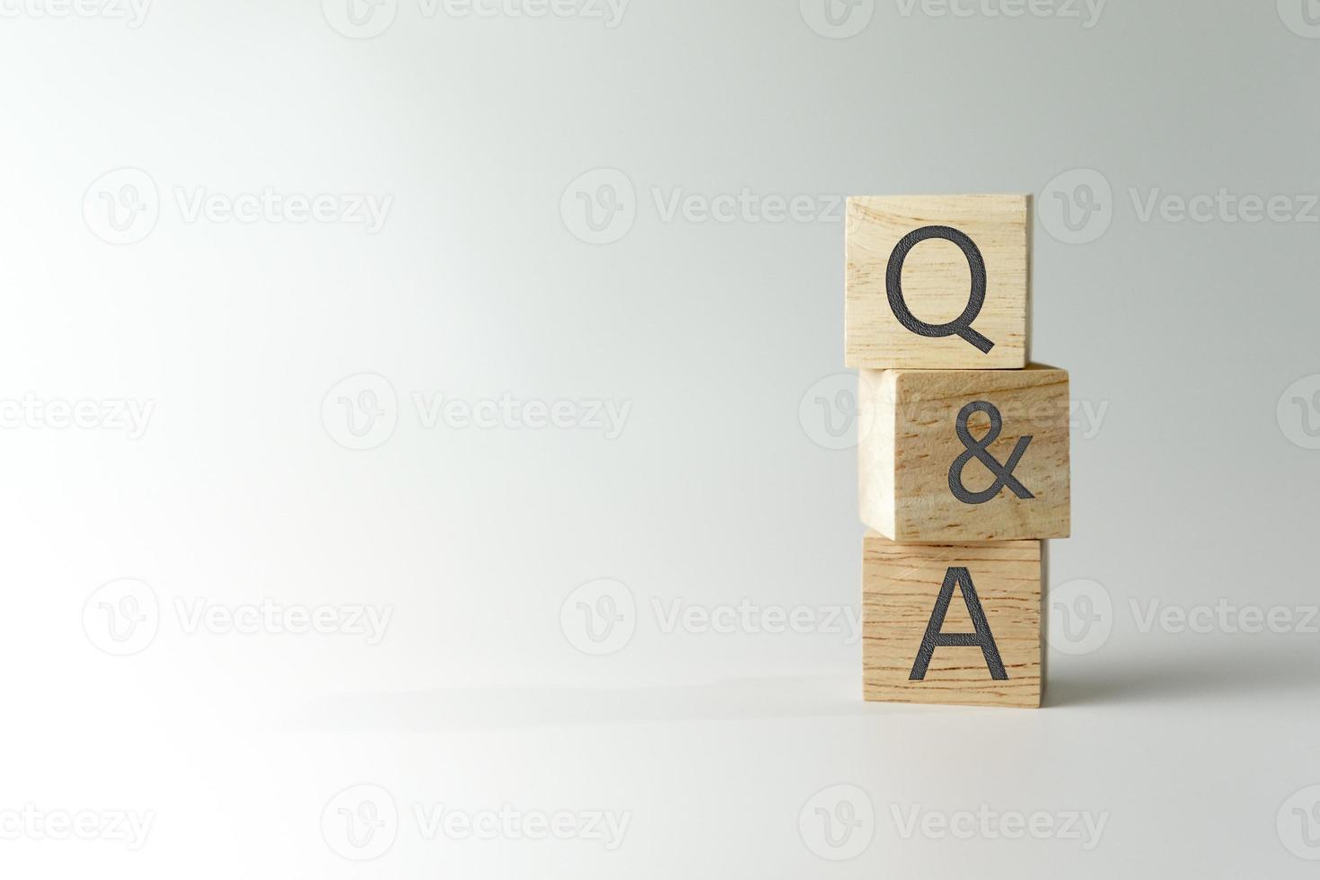 Q and A alphabet on wooden cube. photo